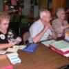 Betty (Potter) Ricketts '55, Emerson Mishler, Clarabell (Beard) Mishler '39 at the registeration table
